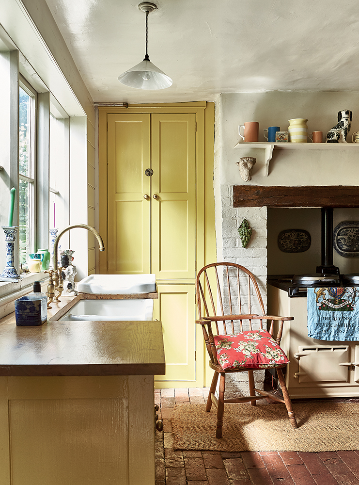 Image from Selina Lake's book Heritage Style of a traditional kitchen with chair by the range