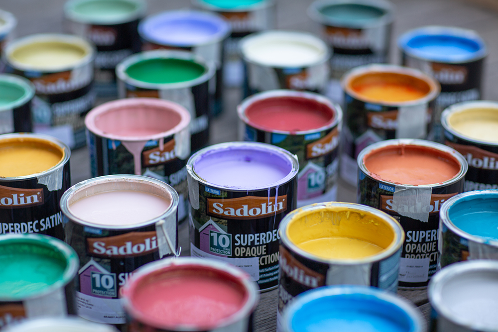 Images of Sadolin Superdec Satin paint pots showing the range of colours