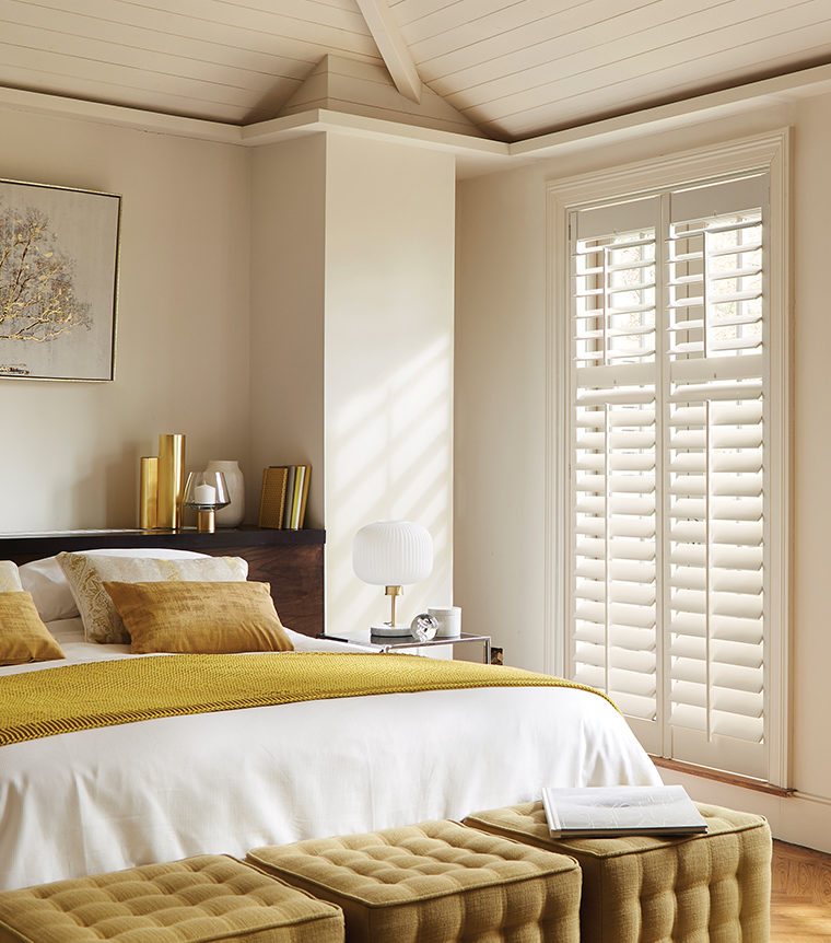 Image of wooden shutters by Luxaflex in a bedroom