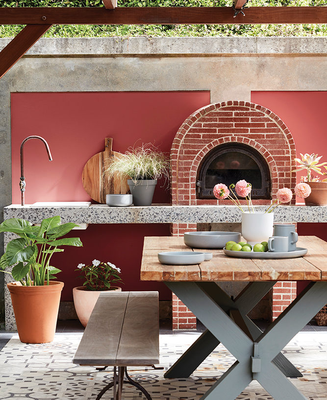 Outdoor kitchen with back wall painted in Little Greene Tuscan Red (140) Intelligent Masonry Paint