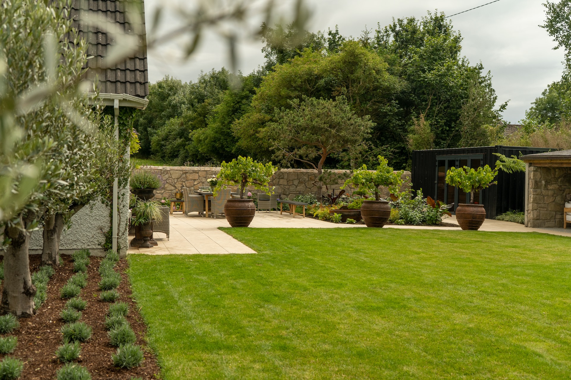 Landscaped garden with planting and outdoor living from Caragh Nurseries.