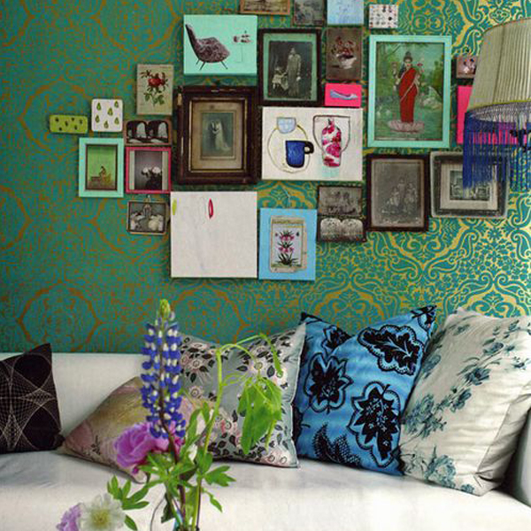 eclectic gallery wall against designers guild wallpaper