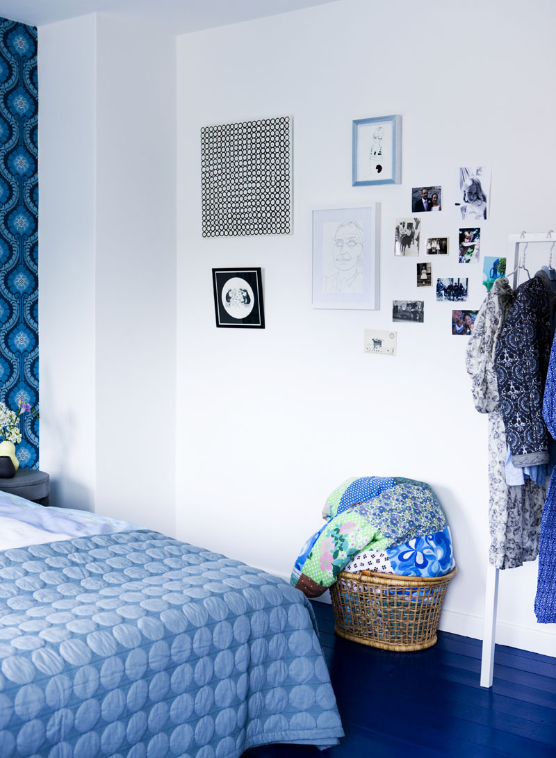 a blue bedroom makeover with frames on the wall