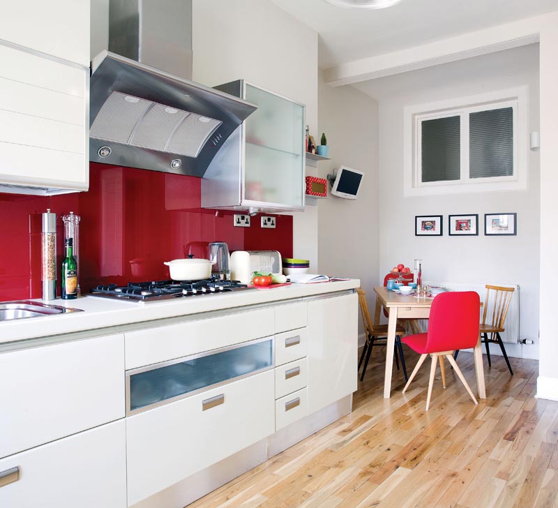 white gloss kitchen with red colourglass splashback